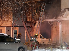 Calgary firefighters deal with a two-alarm fire in a townhouse complex in the 1200 block of Falconridge Drive N.E. on Thursday, Feb. 7, 2017.