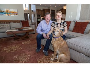 Mona and Darcy Edwards with their dog Charlie in their new home by Albi Luxury by Brookfield Residential in Artesia at Heritage Pointe.