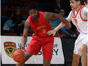 U of C Dinos Thomas Cooper,left, drives to the key as Thompson Rivers University Luke Morris attempts to slow him down during Canada West basketball action at Jack Simpson Gym, University of Calgary Friday night.