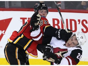 Calgary Flames Sam Bennett battles against Michael Stone of the Arizona Coyotes in Calgary on Jan. 7, 2016. (Al Charest)