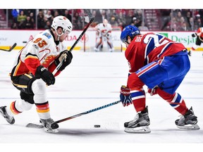 Sam Bennett #93 of the Calgary Flames tries to skate the puck past Nathan Beaulieu #28 of the Montreal Canadiens during the NHL game at the Bell Centre on January 24, 2017 in Montreal, Quebec, Canada.  The Montreal Canadiens defeated the Calgary Flames 5-1.