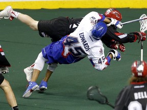 Calgary Roughnecks forward Curtis Dickson collides with Toronto Rock Damon Edwards at the Scotiabank Saddledome in Calgary on Sunday, Feb. 12, 2017. (Leah Hennel)