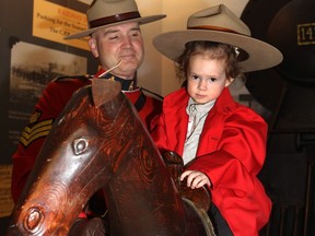 Carina Moffat, 2, meets Sergeant Donovan Fisher during the celebrations at the 141th anniversary of the formation of the North West Mounted Police during Mountie Day at Fort Calgary in 2014. Don a Mountie uniform as part of the Family Day Celebrations this weekend at Fort Calgary.