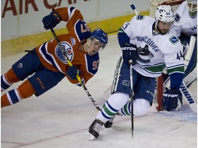 Edmonton Oilers Connor McDavid chases after Vancouver Canucks Matt Bartkowski during first period NHL action on March 18, 2016 in Edmonton.