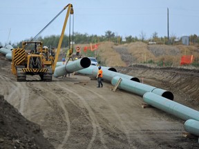 Midwest Construction workers assemble the Enbridge pipeline to Hardisty southeast of New Sarepta in this file photo from Monday Sept. 29, 2014.