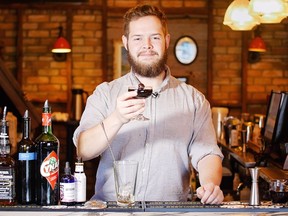 Evan Cooper, a bartender at Cannibale, holds up the Demogorgon Stranger Things inspired cocktail that he dreamed up on January 26, 2017. KERIANNE SPROULE/POSTMEDIA