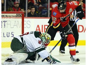 Troy Brouwer tries to jam the puck into the Wild net as the Calgary Flames took on the Minnesota Wild in National Hockey League regular season action on February 1 at the Scotiabank Saddledome.