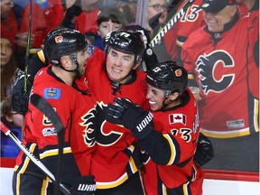 Calgary Flames forward Micheal Ferland celebrates his second-period goal with teammates Mark Giordano, left, and Johnny Gaudreau, right, during a 2-1 overtime win over the Los Angeles Kings at the Scotiabank Saddledome in Calgary on Tuesday, Feb. 28, 2017. (Jim Wells)