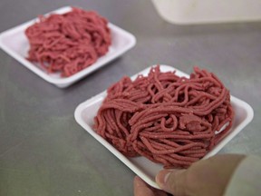 Fresh ground beef is packed at a local butcher shop,  October 1, 2012 in Levis, Que. The federal government has approved the sale of ground beef that has been treated with radiant energy similar to X-rays.Health Canada says irradiation can reduce levels of harmful bacteria such as E. coli and salmonella that could be in the meat.