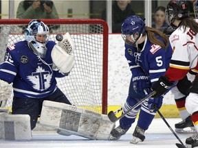 Furies goalie Christina Kessler makes a glove save on the shot from Inferno forward Rebecca Johnston as the Calgary Inferno took on the Toronto Furies at the Winsport sportsplex in Calgary, Alta., on February 25, 2017.