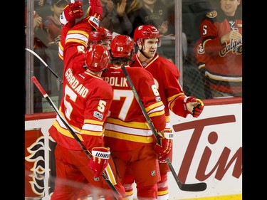 The Calgary Flames celebrate their first goal of the game against the Philadelphia Flyers during NHL action in Calgary, Alta., on Wednesday, Feb. 15, 2017. Lyle Aspinall/Postmedia Network
