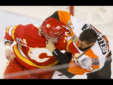 Micheal Ferland of the Calgary Flames fights with Pierre-Edouard Bellemare of the Philadelphia Flyers during NHL action in Calgary, Alta., on Wednesday, Feb. 15, 2017. Lyle Aspinall/Postmedia Network