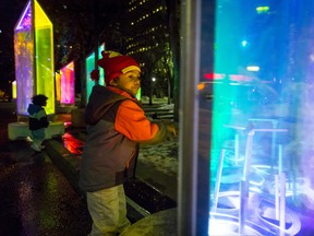 Nathan Fernando, 4, spins a towering prism in the Prismatica art installation at Olympic Plaza in Calgary, Alta., on Thursday, Feb. 16, 2017. The temporary display of about two dozen two-metre-high rainbow towers is a precursor to the inaugural GLOW Winter Light Festival happening over the Family Day weekend. Lyle Aspinall/Postmedia Network