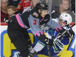 Calgary Hitmen's Jakob LaPointe hits Swift Current Broncos' Kole Gable on Saturday, Feb. 11, 2017. (Jim Wells)