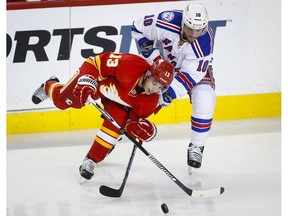 J.T. Miller battles with Calgary Flames' Johnny Gaudreau on Nov. 12, 2016. Before the two teams meet on Sunday, the Flames will skate at Central Park. (The Canadian Press)