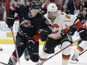 Carolina Hurricanes' Jeff Skinner (53) and Calgary Flames' Dougie Hamilton (27) chase the puck during the second period of an NHL hockey game in Raleigh, N.C., Sunday, Feb. 26, 2017.