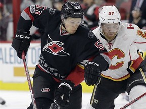 Carolina Hurricanes' Jeff Skinner (53) and Calgary Flames' Dougie Hamilton (27) chase the puck during the second period of an NHL hockey game in Raleigh, N.C., Sunday, Feb. 26, 2017.