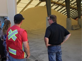 Kevin Morrison, regional operations manager for Source Energy Services, right, gives residents a tour of the the new frac sand terminal in Wembley Alta., in this 2014 file photo.