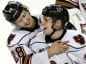 Left, Tyler Mrkonjic embraces Jakob Stukel after his overtime game winning goal as the Calgary Hitmen defeated the Edmonton Oil Kings 2-1 at the Scotiabank Saddledome in Calgary, Alta., on February 17, 2017.
