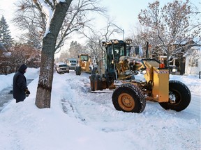 City graders make their way along 12th Avenue N.W. on Tuesday. Reader says residents in his neighbourhood, Signal Hill, were left with high windrows at the end of their driveways.