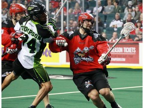 The Calgary Roughnecks' Tyler Burton, right and Curtis Manning move the ball between the Saskatchewan Rush's Jeremy Thompson during National Lacrosse League action at the Scotiabank Saddledome in Calgary on Saturday February 4, 2017. The teams played Sunday in Saskatoon, Sask., with the Rush pulling out a 12-11 OT win.