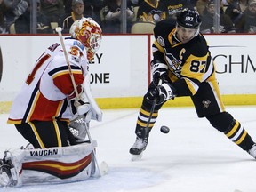 Pittsburgh Penguins' Sidney Crosby (87) can't get a shot past Calgary Flames goalie Chad Johnson during the second period of an NHL hockey game in Pittsburgh, Tuesday, Feb. 7, 2017.