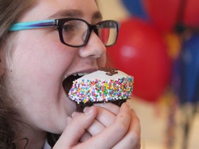 Lauren Charbonneau, 12 yrs, takes a bite of a cupcake during the launch of the new initiative "Give More Birthdays" at Crave Cupcakes in Calgary, Alta on Wednesday February 15, 2017. The initiative for Kids Cancer Care formalizes what is alteady a trend among some kids to aske for charitable donations in lieu of birthday gifts. Jim Wells//Postmedia