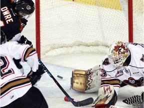 Tigers Steven Owre pots the game tying goal against goalie Kyle Dumba as the Calgary Hitmen took on the Medicine Hat Tigers in WHL regular season action at the Scotiabank Saddledome in Calgary, Alta., on February 24, 2017.