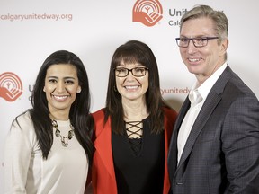 Rich Kruger, president and CEO of Imperial Oil, and Manjit Minhas (L), CEO of Minhas Breweries & Distillery, stand for a photo with Karen young, president and CEO of United Way of Calgary and Area, during the Spirits of Gold breakfast at the Telus Convention Centre in Calgary, Alta., on Monday, Feb. 13, 2017. Kruger and Minhas were announced as the new co-chairs of the next year's United Way of Calgary and Area campaign.