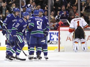 Vancouver Canucks defenceman Alexander Edler (23) celebrates his goal against the Calgary Flames with teammates left wing Loui Eriksson (21) centre Brandon Sutter (20) defenceman Troy Stecher (51) and centre Jayson Megna (46) during first period NHL hockey action in Vancouver on Feb. 18, 2017.