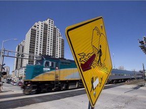 VIA Rail train 73, carrying passengers from Toronto to Windsor, rolls across Ridout Street in London, Ont. on Wednesday April 27, 2016. Craig Glover/The London Free Press/Postmedia Network