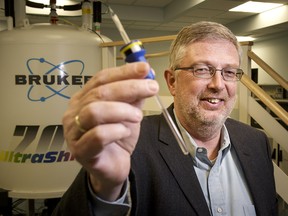 Dr. Hans Vogel holds a protein sample at the University of Calgary Wednesday. A study by the Faculty of Science identified a "molecular switch" in L-plastin, a protein known to play a significant role in tumour metastasis.