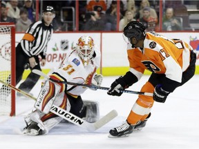 Philadelphia Flyers' Wayne Simmonds, right, scores a goal past Calgary Flames' Chad Johnson during the second period of an NHL hockey game, Sunday, Nov. 27, 2016, in Philadelphia. The Flames host the Flyers on Wednesday.