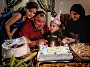 Yahya Al Masalmeh and his wife Seham Talab celebrate their son Mohammad's first birthday at their home in Calgary with family, including youngest daughter Najat Al Masalmeh, 8.