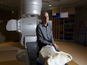 Chris Kucharski, cancer survivor, poses in the radiation room at the Tom Baker Cancer Centre in Calgary, Alta., on Friday March 10, 2017. Leah Hennel/Postmedia