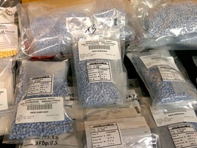 Calgary Police display on December 29, 2016 a large amount of drugs, cash and various weapons following a one month operation. A record amount of fentanyl pills, loaded guns and other weapons have been seized during a police operation targeting drug trafficking in Calgary, Alta.