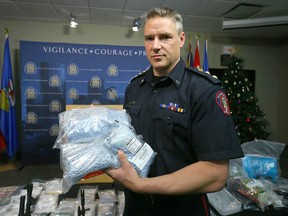 FILE PHOTO: Calgary Police Acting Insp Mark Hatchette of the Strategic Enforcement Unit displays on December 29, 2016 a large amount of drugs, cash and various weapons following a one month operation.
