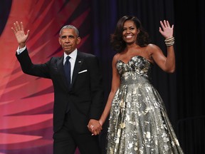 FILE - This Sept. 17, 2016 file photo shows President Barack Obama and first lady Michelle Obama at the Congressional Black Caucus Foundation's 46th Annual Legislative Conference Phoenix Awards Dinner in Washington. The former president and first lady have signed with Penguin Random House, the publisher announced Tuesday, Feb. 28, 2017. (AP Photo/Pablo Martinez Monsivais, File) ORG XMIT: NYET231