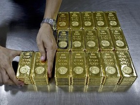 A technician prepares gold bars for delivery in Dubai, United Arab Emirates, Oct.8, 2012. With commodity prices on the rise, attendees at the world&#039;s largest annual gathering for the mining industry are expected to be cheerier than they were last year. THE CANADIAN PRESS/AP, Kamran Jebreili