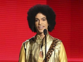 FILE - In this Nov. 22, 2015 file photo, Prince presents the award for favorite album - soul/R&B at the American Music Awards in Los Angeles. People magazine reported online on March 15, 2017, that Prince‚Äôs ex-wife says is opening up about the couple‚Äôs baby who died just six days after being born with a rare genetic disorder in 1996. Mayte Garcia writes in a new memoir that baby Amiir was born in Oct. 1996 with Pfeiffer syndrome type 2, a disorder that causes skeletal abnormalities. (Photo b
