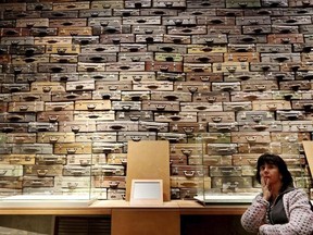 FILE -In this file photo taken in Gdansk, Poland, Jan. 23, 2017, a woman looks at an exhibit in the Museum of the Second World War, an ambitious new museum under creation for nine years, that opened its doors then for one day to historians and reporters. It opened to visitors on Thursday, March 23, 2017, amid plans by the conservative government to change its content to fit its nationalist views. (AP Photo/Czarek Sokolowski, File)