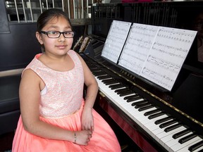 Nine-year-old Mehar Kaur Vilkhu sits with her piano at home in Calgary, Alta., on Saturday, March 18, 2017. She's one of 12 kids from around the world who will be part of Juilliard School's Summer Performing Arts Program for two weeks in Geneva. Lyle Aspinall/Postmedia Network