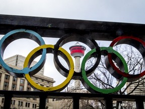 The Calgary Tower is seen with Olympic rings built into railing at Olympic Plaza in downtown Calgary.