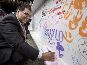 Mayor Naheed Nenshi signs a steel beam at the site of the new Central Library Tuesday.