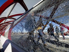 A smashed pane of glass sits in the Peace Bridge over the Bow River in Calgary, Alta., on Sunday, Nov. 13, 2016. Vandals have caused more than $200,000 in damage to the Peace Bridge, forcing the city to upgrade the security camera system in the area. Lyle Aspinall/Postmedia Network