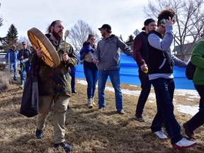 Marchers unfurl a blue banner representing an underground creek during "Rally in the Valley" event in Calgary, Alta., on Saturday, March 18, 2017. The Save the Highland Valley Wetlands rally was in opposition to a high-rise development planned for the green space near 40 Ave. and 4 St. N.W. Bryan Passifiume/Postmedia Network