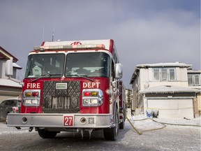 A fire truck sits outside of 274 Panamount Court NW after an overnight fire in Calgary, Alta., on Tuesday, March 7, 2017. All six occupants of the home made it out safely; the cause is under investigation. Lyle Aspinall/Postmedia Network