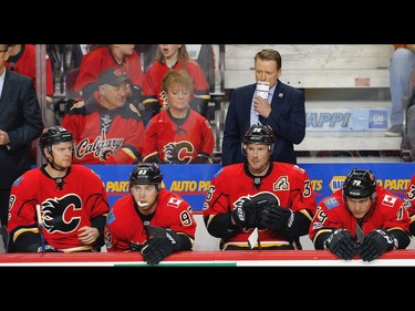 Calgary Flames bench during a break in play while facing the Boston Bruins in NHL hockey in Calgary, Alta. on Wednesday March, 15, 2017. AL CHAREST/POSTMEDIA