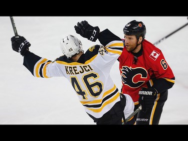 Boston Bruins David Krejci collides with Dennis Wideman of the Calgary Flames during NHL hockey in Calgary, Alta., on Wednesday, March 15, 2017. AL CHAREST/POSTMEDIA