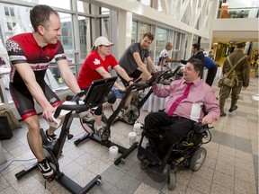 Cyclists (L-R) Shane Kups, Patti Critchley and Zak Halas raise money for a trip to Vimy while being chatted up by Minister of Veteran Affairs Kent Hehr in the Plus 15 at Bankers Hall in downtown Calgary, Alta., on Thursday, March 30, 2017. Team YYCBBR17 is raising money to be part of the Wounded Warriors Canada Battlefield Bike Ride in June, which will trace the path from London to Vimy that Canadian soldiers took in the First World War and raise money for Wounded Warriors Canada. Lyle Aspinall/Postmedia Network